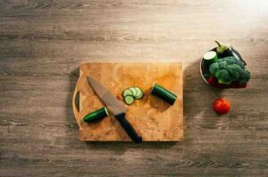 A chopping board and chopper on the table 