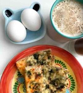 Inviting breakfast setting with pizza, eggs, and coffee. Perfect cozy meal